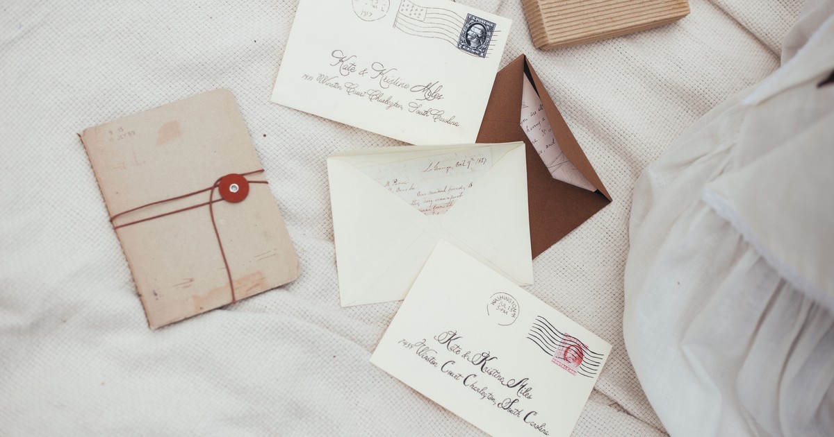 Wedding invitation envelopes addressed in calligraphy with full guest names and a spelled-out address